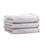 Stack of four folded textured Non-Scratch Dishwashing Cloth on a white background