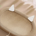 Woven Sisal Cat Scratch Board with cat ears on a beige background.